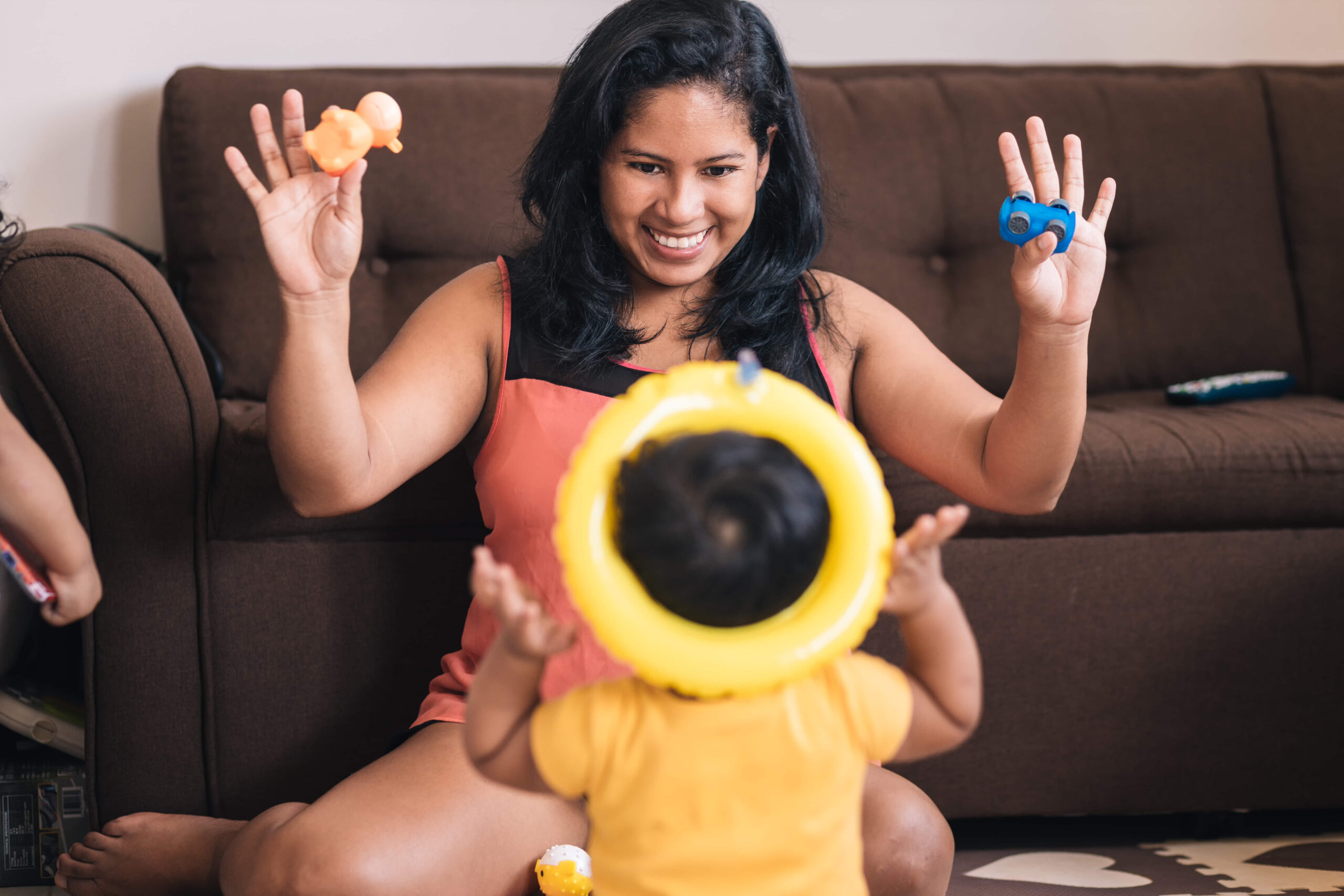 mom-sitting-on-the-floor-playing-with-her-child-2023-11-27-04-58-07-utc